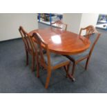 An inlaid yew wood twin pedestal dining table together with a set of four shield back chairs