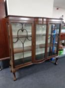 An Edwardian mahogany bowfronted display cabinet on claw and ball feet