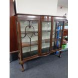 An Edwardian mahogany bowfronted display cabinet on claw and ball feet