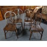 A set of four wheel back kitchen chairs