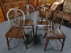 A set of four wheel back kitchen chairs
