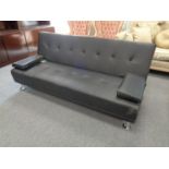 A black faux leather folding sofa bed, boxed.