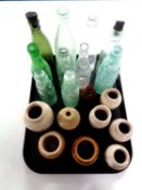 A tray containing a quantity of antique stoneware and glass bottles.