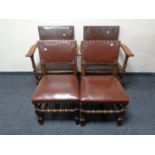 A set of four oak leather buttoned dining chairs comprising of two carvers and two singles