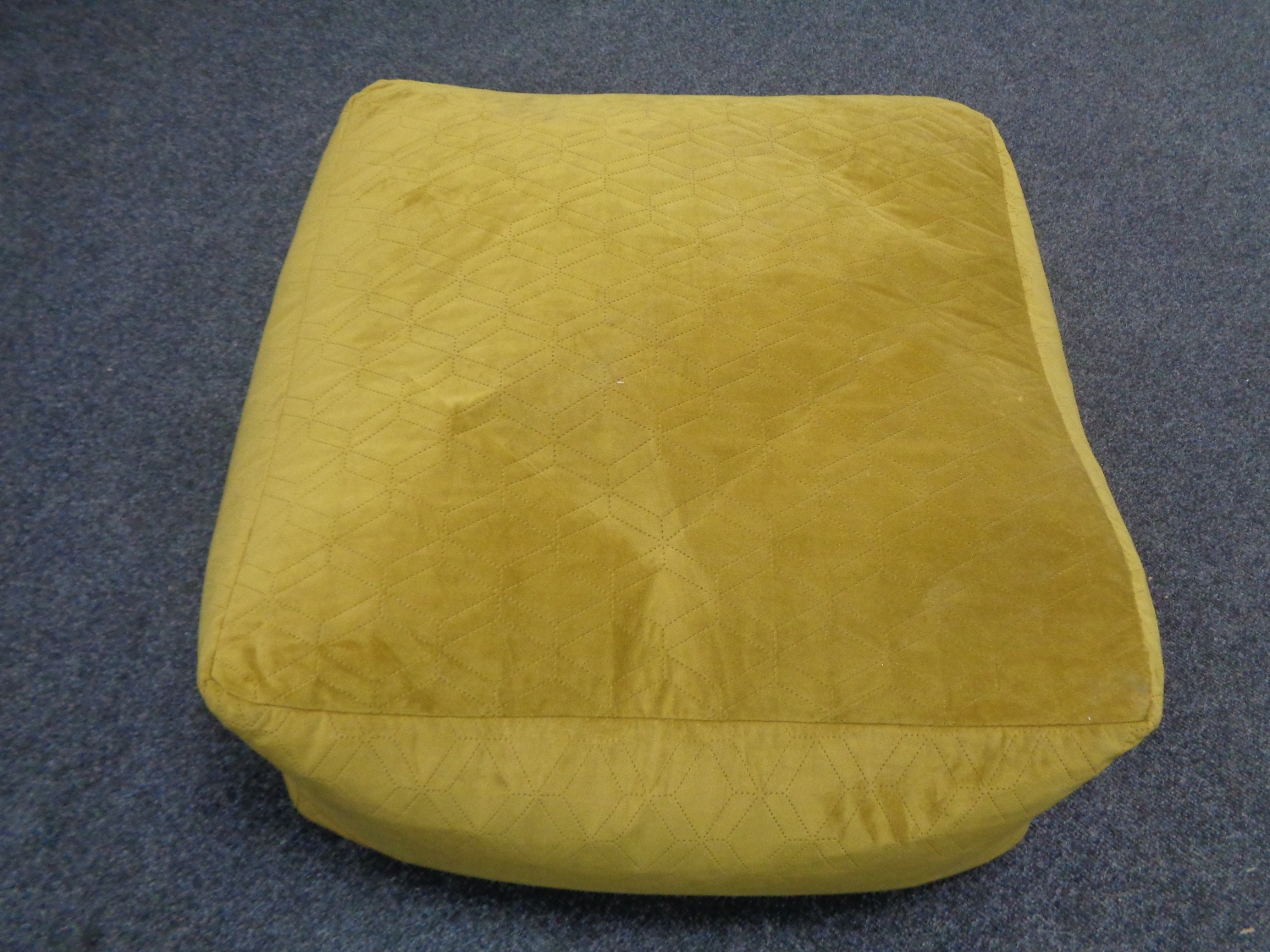 A contemporary yellow footstool