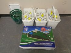 Three tubs containing a large quantity of golf balls together with a putting machine