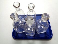 A tray of a set of five Dartington crystal decanters with stoppers,