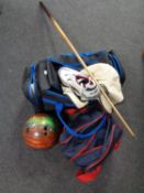 Two bowling bags containing bowling balls and shoes together with a pool cue