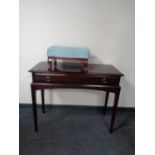 A Stag Minstrel console table and a further upholstered footstool