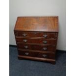 An inlaid mahogany writing bureau fitted with four drawers