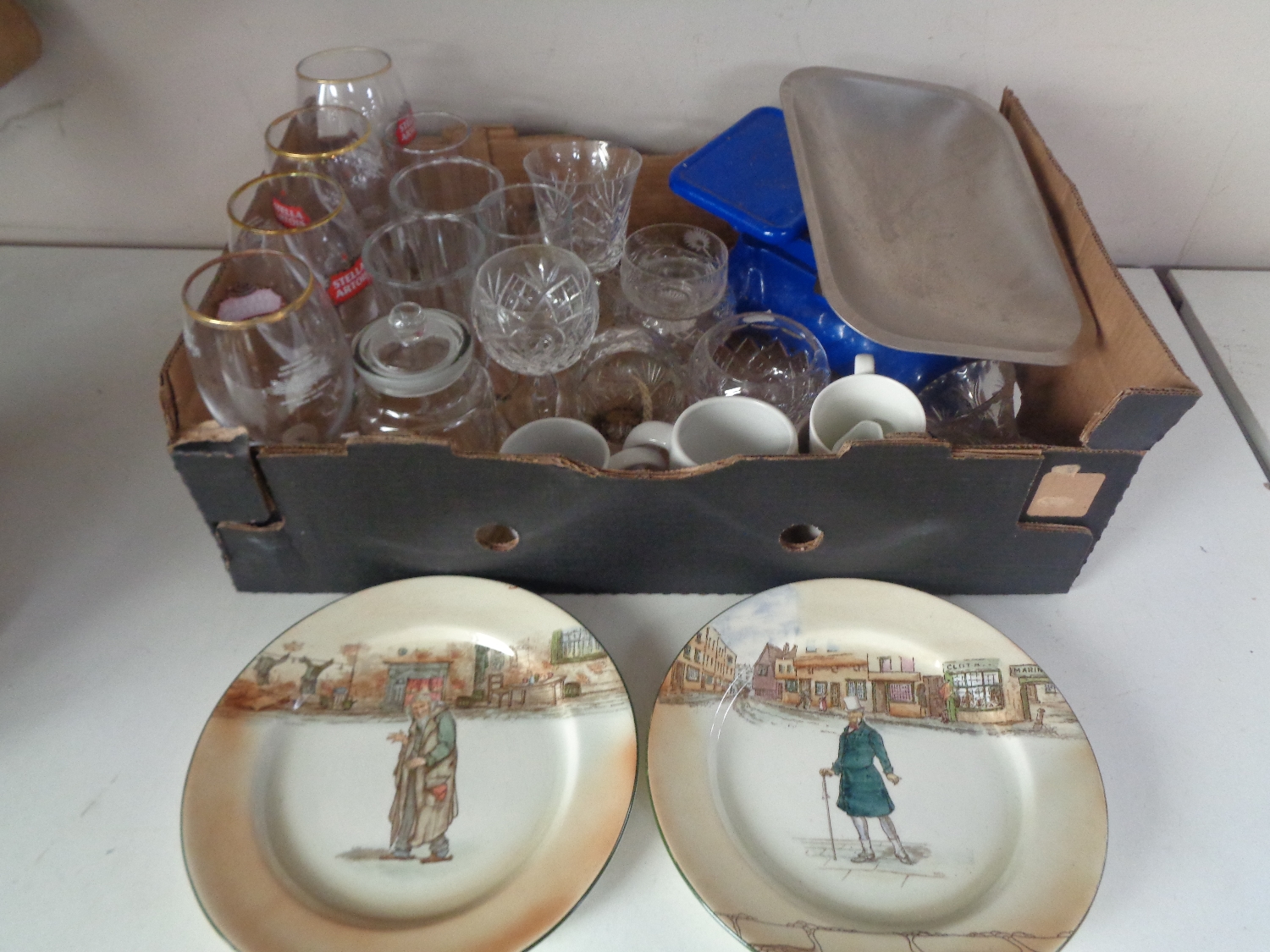 A box containing vintage kitchen scales, assorted drinking glasses,