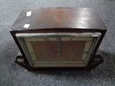 A 1930s oak cased continental mantel clock.