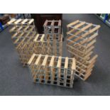 Seven wood and metal wine racks of various sizes