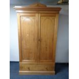 An Aesthetic period pine double door wardrobe fitted drawer beneath