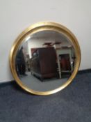 A contemporary gilt circular bevelled mirror