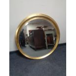 A contemporary gilt circular bevelled mirror