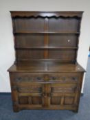 A 20th century carved oak two door two drawer Welsh dresser.