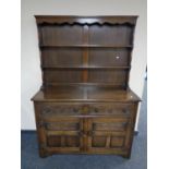 A 20th century carved oak two door two drawer Welsh dresser.