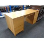 A contemporary three drawer single pedestal desk with slide together with two drawer filing chest