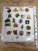 A quantity of continental enamelled pin badges on card