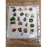 A quantity of continental enamelled pin badges on card