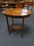 An Edwardian inlaid mahogany oval two tier occasional table.