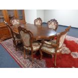 An Italian style shaped twin pedestal dining table with six chairs, two carvers and four singles.