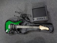 A Display4Top electric guitar in carry bag together with a Display4Top EG-20W amplifier and a