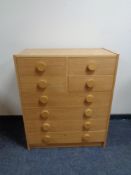 A 20th century eight drawer chest in an oak finish.