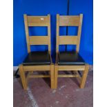 A pair of contemporary oak high backed dining chairs