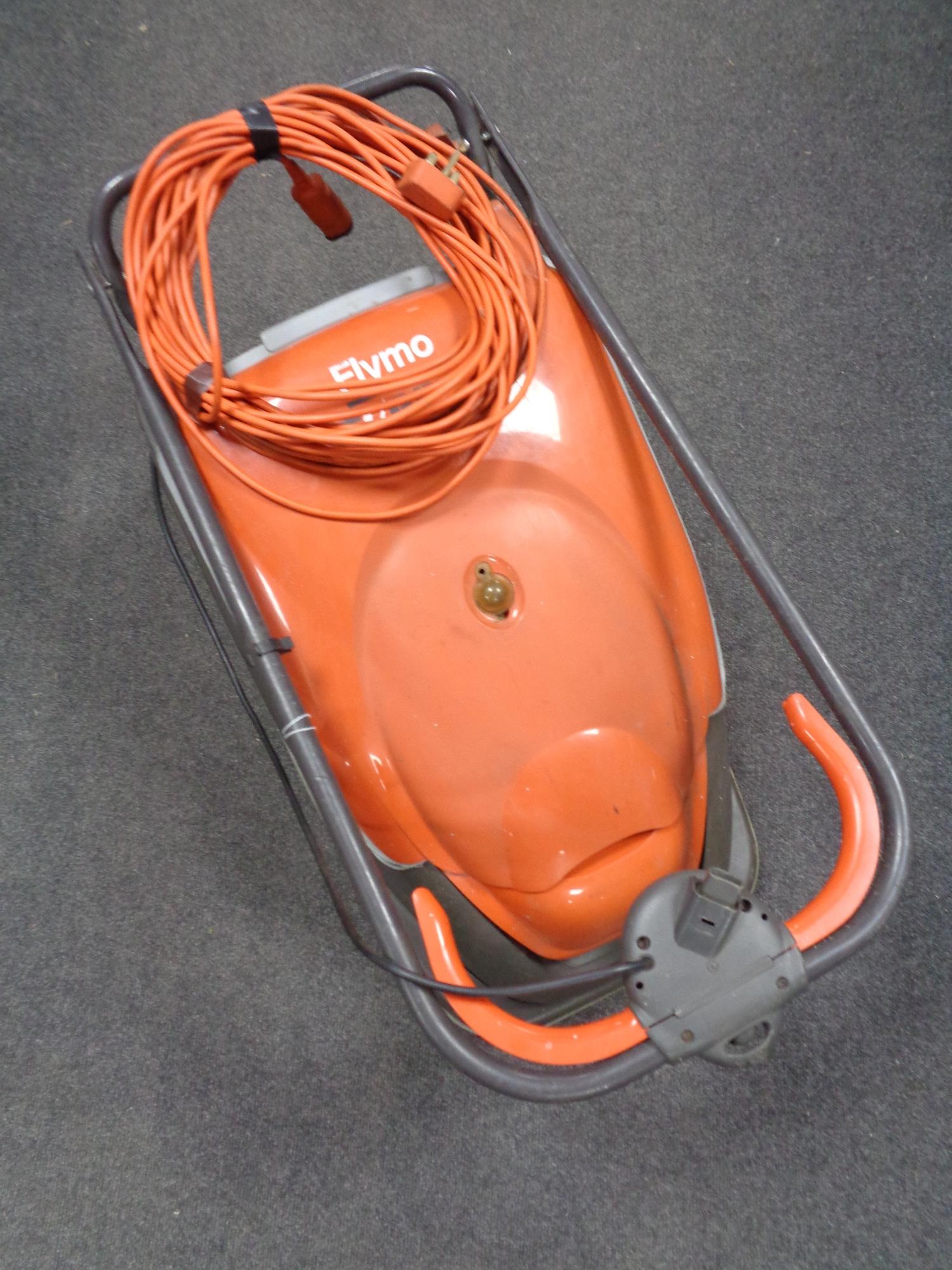 A Flymo Turbo Compact 380 lawn mower with lead.