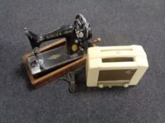 A vintage Singer hand sewing machine together with a cream Bakelite cased Ekco radio.