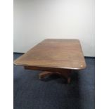 A Victorian mahogany pedestal dining table with leaf