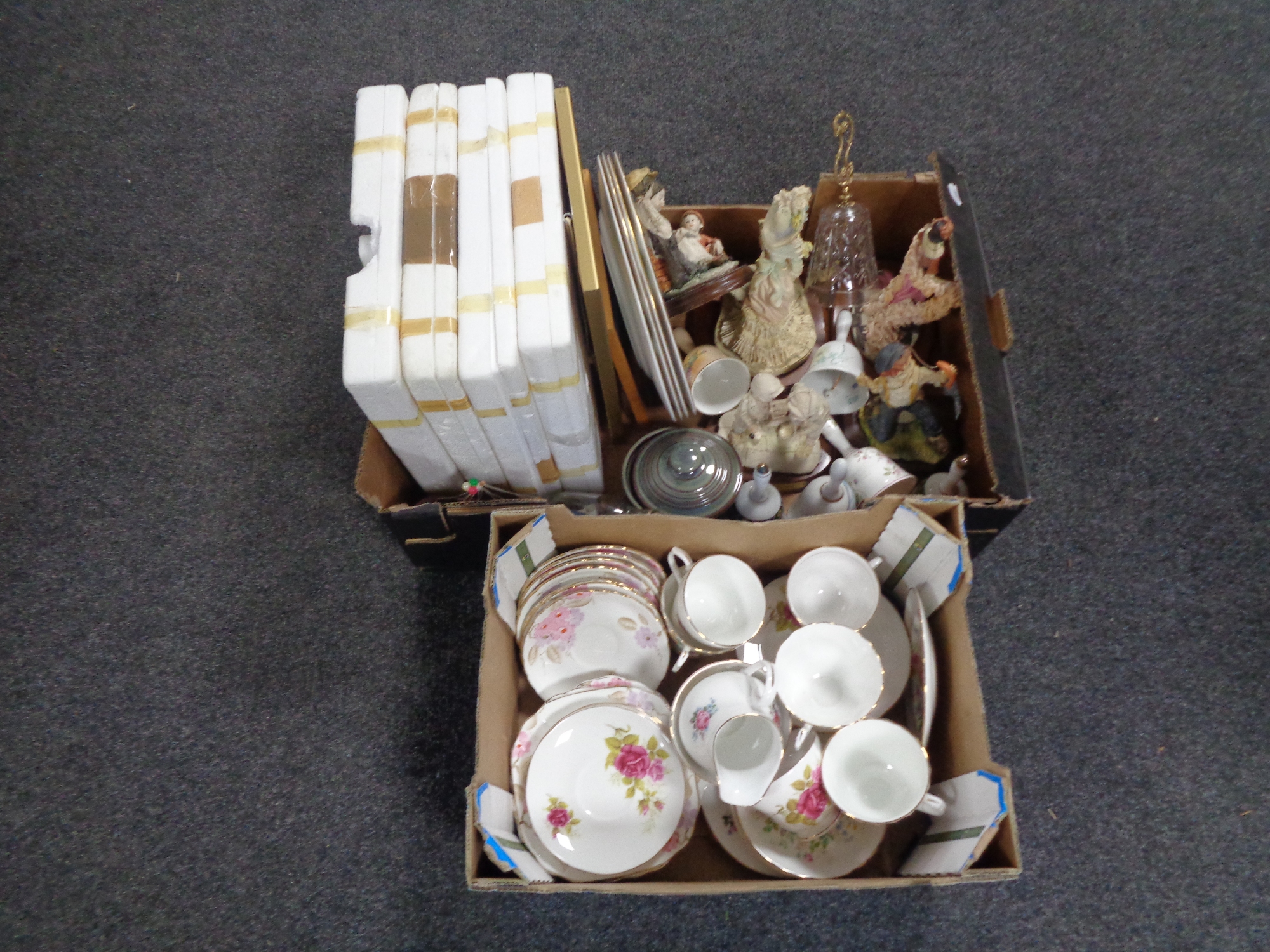 Two boxes containing miscellaneous tea china, eight Sutherland bone china train plates, figurines,