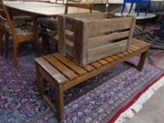 A vintage wooden crate together with a slatted wooden bench