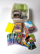 A box containing a small quantity of Pokemon and -Yu-gi-oh cards, football stickers and cards.