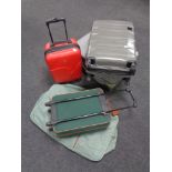 Three hard shell luggage cases together with a further luggage case,