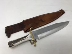 A heavy quality bowie knife, marked Colt, with simulated horn grip, blade length 28 cm,