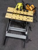 A folding work bench together with a box containing Performance reciprocating saw and two pressure