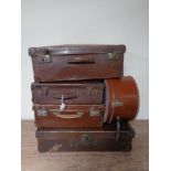 Four vintage leather luggage cases together with a leather hat box