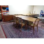 A mid 20th century teak McIntosh furniture eight piece dining room suite comprising of triple door