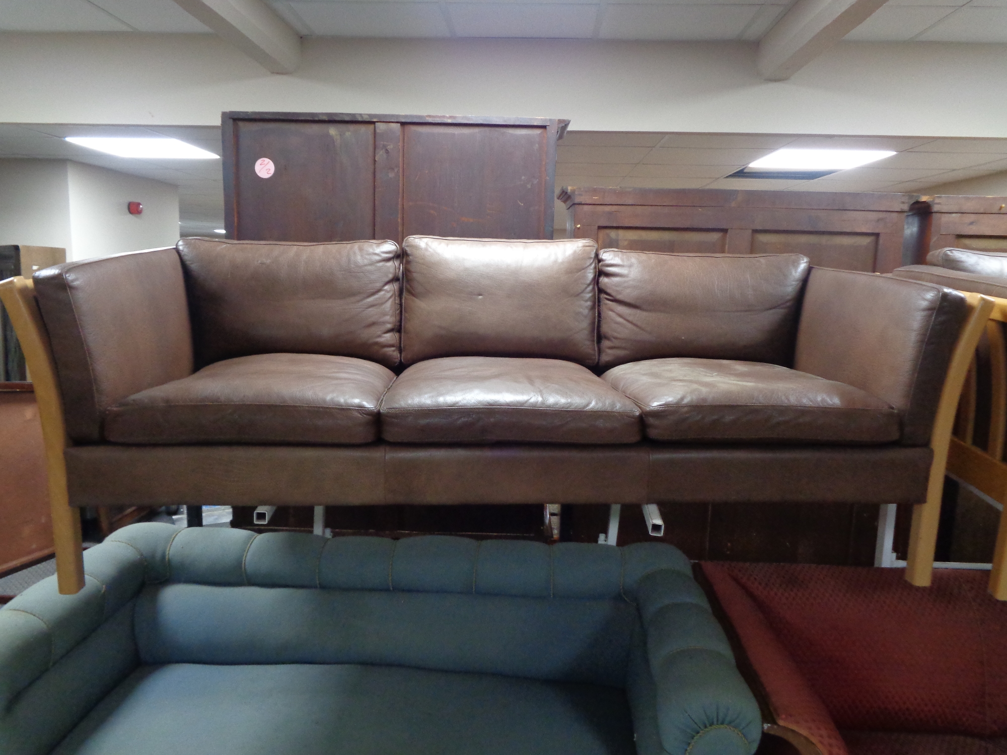 A 20th century Stouby wood framed brown leather three seater settee with matching two seater settee. - Image 2 of 3