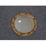 A circular bevel edged barbola style mirror.