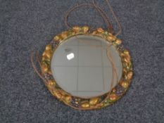 A circular bevel edged barbola style mirror.