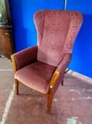 A 20th century Shackletons wingback armchair upholstered in a pink fabric