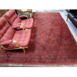 A Bokhara carpet, Afghanistan, on red ground.