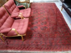 A Bokhara carpet, Afghanistan, on red ground.