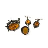 A vintage amber brooch, ring and pair of earrings.