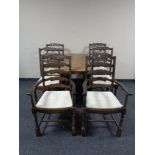 A gate leg table together with a set of six Priory oak ladder back chairs comprising of two carvers