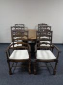 A gate leg table together with a set of six Priory oak ladder back chairs comprising of two carvers